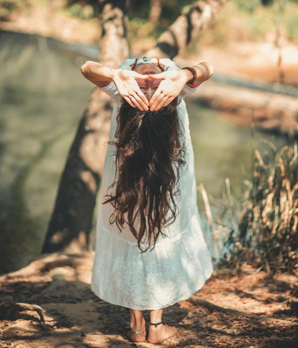 Woman performing a fluid yoga pose in a calm environment.